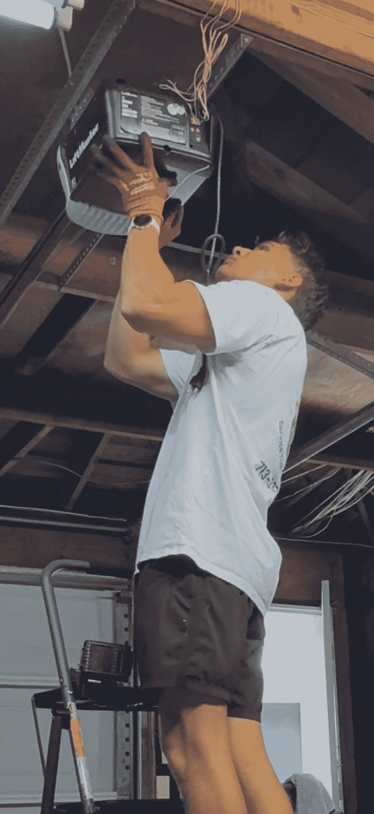 Space City Garage Doors technician holding a LiftMaster garage door opener motor