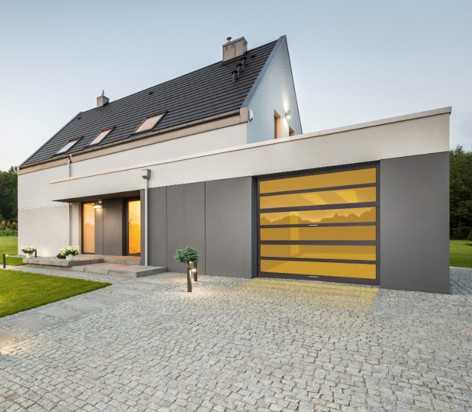 Full view glass garage door on a modern home at dusk
