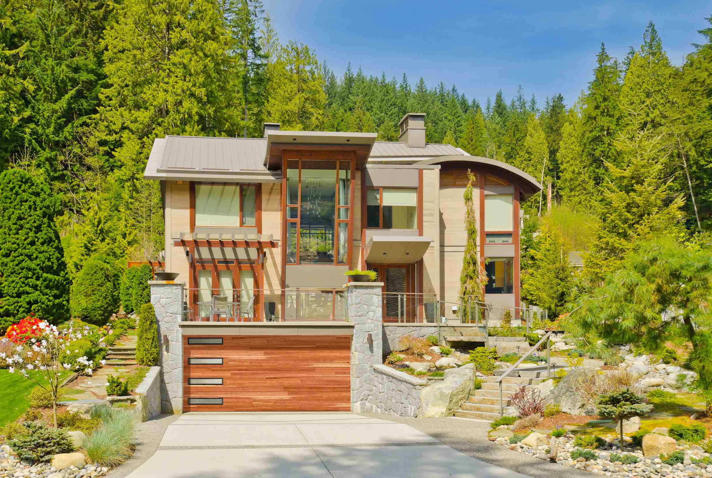Modern plank glazed cedar steel double garage door on a contemporary home