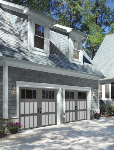 Steel carriage house garage doors on a two-story home